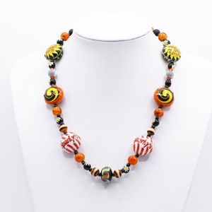 Bottle cap necklace in orange and black.  Retro American recycled bottle tops. Brewing memorabilia