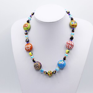 Retro American recycled bottle tops and bright millefiori glass beads make up this vibrant necklace.