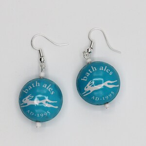 Leaping hare bottle top earrings. Turquoise and white.  Bath ales, matching necklace.