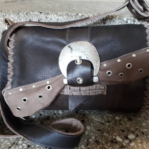 brown leather bag with large buckle, eyelets and rivets, to wear over the shoulder, handmade unique piece