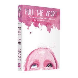 Könnte beinhalten: Ein rosa und weißes Buch mit dem Titel "PULL ME APART" und dem Untertitel "An Interactive Sketchbook by Heather Clements". Der Umschlag zeigt eine Aquarell-Illustration eines Gesichts mit einem offenen und einem geschlossenen Auge.