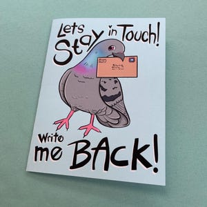 May include: A light blue greeting card featuring a cartoon pigeon holding a letter. The card reads "Lets Stay in Touch! Write me BACK!" in black and white text. The pigeon is gray with pink feet and a purple chest.