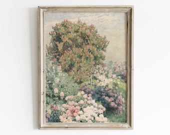 May include: A framed painting of a garden scene with a large tree in the center, surrounded by pink and white flowers. The tree has red and green leaves. The painting is in a light wood frame.