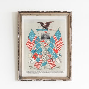 May include: A framed vintage print of a patriotic illustration featuring an eagle with outstretched wings above a collection of American flags. The flags are arranged in a starburst pattern with the text "FLAGS OF THE UNION" at the center. The print is titled "DECLARATION OF INDEPENDENCE, JULY 4, 1776."
