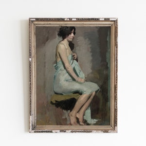 May include: A framed oil painting of a woman sitting on a stool, wearing a light blue draped garment. The woman is facing away from the viewer, and her hair is pulled back. The painting is set against a neutral background.