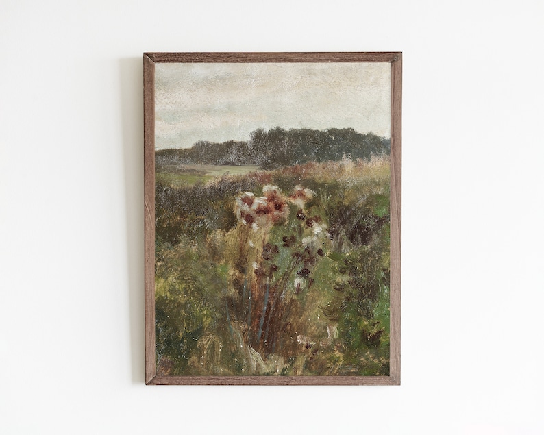 May include: A framed painting of a landscape with a field of wildflowers in the foreground and a forest in the background. The sky is cloudy and the colors are muted.