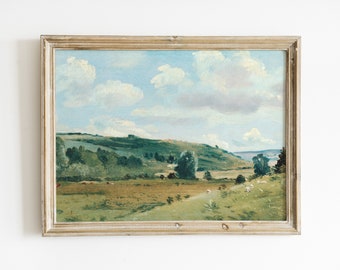May include: A framed painting of a landscape with rolling hills, green trees, and a blue sky with white clouds. The painting is in a light wood frame.