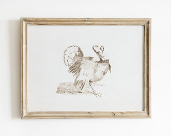 May include: A framed black and white drawing of a turkey with its feathers ruffled. The frame is a light wood color.