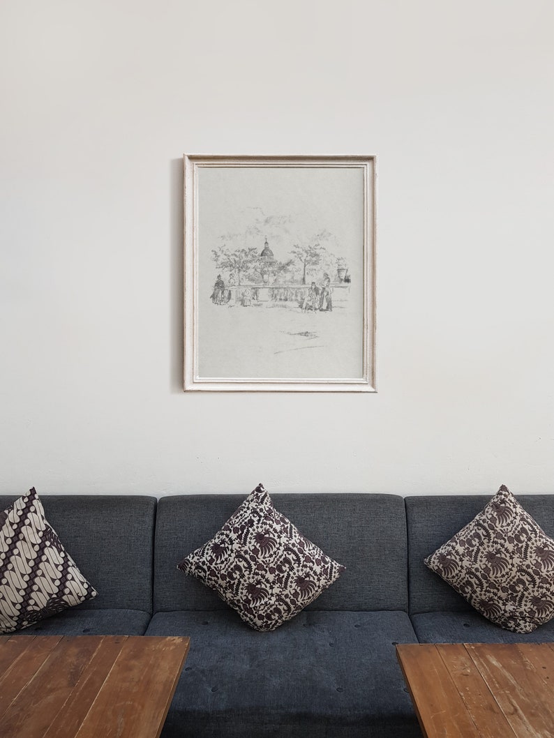 May include: A framed black and white sketch of a city scene with a domed building in the background. The sketch is on a light gray background and is framed in a white frame.