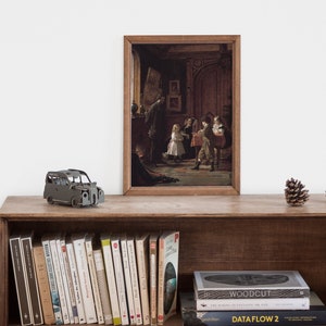 May include: A framed painting of a group of children in a room with a fireplace and a large wooden door. The children are dressed in 19th-century clothing and are playing a game. The painting is in a wooden frame and is hanging on a wall.