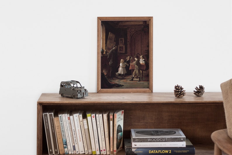 May include: A framed painting of a group of children in a room with a fireplace and a large wooden door. The children are dressed in 19th-century clothing and are playing a game. The painting is in a wooden frame and is hanging on a wall.