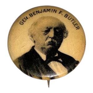 May include: A vintage circular button with a black and white portrait of Gen. Benjamin F. Butler. The button has a pin on the back and text around the edge.