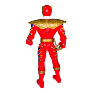 May include: A red action figure with gold and blue accents. The figure has a gold shoulder piece and belt, with blue and yellow zigzag patterns on the legs and arms. A gold weapon is attached to the figure's side.