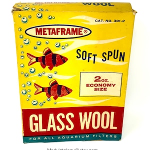 May include: Vintage Metaframe glass wool box. The yellow box features red and black fish illustrations and the words "Soft Spun" and "Glass Wool". The box is labeled "2 oz. Economy Size" and is for aquarium filters.