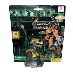 May include: A green and gold Bronto Bot Dino Squad toy in its original packaging. The packaging features the text "Bronto Bot" and "Dino Squad", along with a graphic of a robot. The toy is a form-changer.