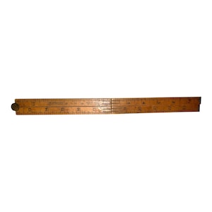 May include: A vintage wooden folding ruler, featuring a brass rivet and etched markings. The ruler is a warm, natural wood tone, with measurements in inches. The ruler is folded in the middle, showing the hinge and the markings.