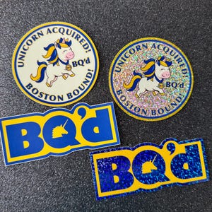 May include: Four stickers with a unicorn theme. Two circular stickers feature a unicorn illustration with the text "UNICORN ACQUIRED! BOSTON BOUND!" and "BQ'd". Two rectangular stickers display "BQ'd" with a unicorn silhouette.