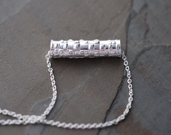 Modern minimalist hand formed silver tube necklace with geometric texture, one of a kind