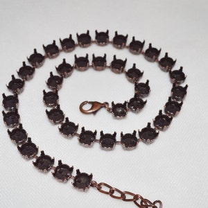 May include: A copper-toned chain with a clasp, designed to hold rhinestones or other embellishments. The chain is made of metal and has a smooth, polished finish.