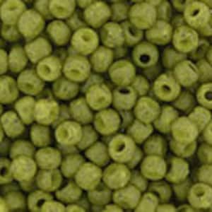 May include: A close-up view of a large quantity of small, green, round beads. The beads have a slightly textured surface and a hole in the center.