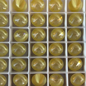 12 pieces 1122 Soft Yellow Ignite 12mm Crystal Rivolis