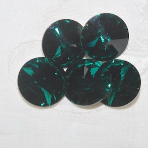 May include: Five round, dark green, faceted glass buttons.