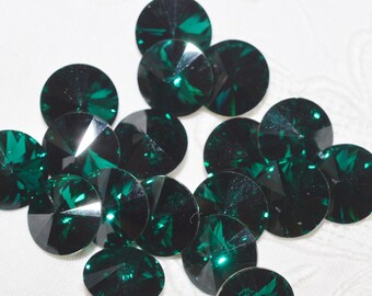 May include: A collection of emerald green round rhinestones with a faceted design.