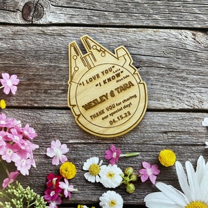 May include: A wooden laser-cut Star Wars Millennium Falcon-shaped thank you card with the text "I love you" - Lela, "I know" - Han Solo, Wesley & Tara, Thank you for sharing our special day! 04.15.23.