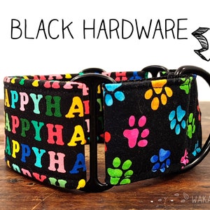 May include: Black dog collar with a colourful paw print pattern and the word "HAPPY" repeated on the other side. The collar has black hardware.