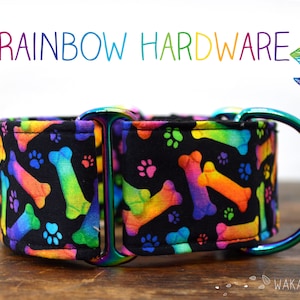May include: A black dog collar with a rainbow bone and paw print pattern. The collar has a silver metal buckle and D-ring.