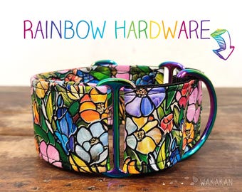 May include: A dog collar with a floral stained glass pattern. The collar features a rainbow-colored metal hardware and the text "RAINBOW HARDWARE". The collar is made of a colorful fabric with flowers in shades of pink, blue, yellow, and orange.