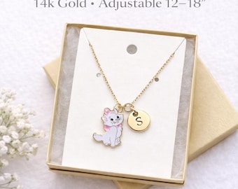 May include: A gold-colored necklace with a pendant featuring a white cat with a pink bow and a gold-colored initial charm. The necklace is in a gift box. Text on the image reads: 14k Gold • Adjustable 12–18".