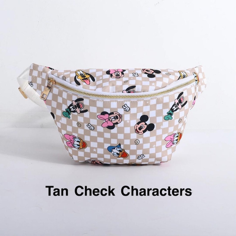 May include: Tan and white checkered fanny pack featuring cartoon characters. The bag has a gold zipper and a white strap. The text "Tan Check Characters" is printed on the bottom.