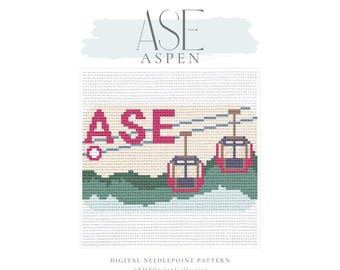 May include: Digital needlepoint pattern featuring the word "ASE" in pink, with two ski gondolas and the word "Aspen" above. The design includes a mountain scene in shades of green and blue.