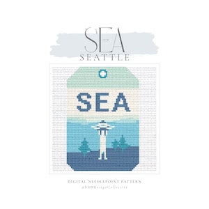 May include: A digital needlepoint pattern featuring a tag-shaped design with the text SEA. The graphic includes a stylized Space Needle icon in shades of blue, teal, and white, set against a grid background. The top text reads SEA SEATTLE.