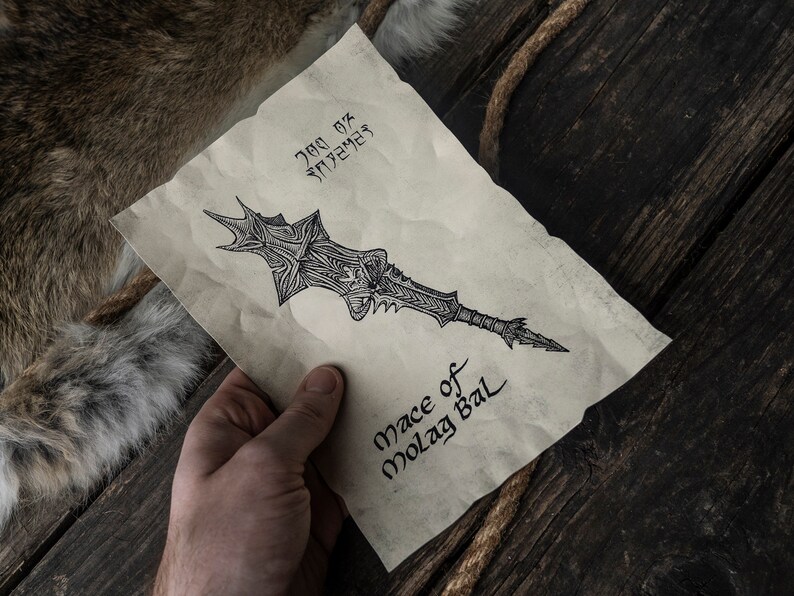 May include: A hand holds a piece of parchment paper with a drawing of a sword and the text "Mace of Molag Bal".