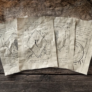 May include: Four pieces of parchment paper with handwritten text and symbols. The parchment is aged and has a worn look. The text is in a dark ink and includes a variety of symbols and designs.