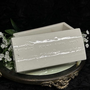 May include: A white rectangular box with a lid. The box has a textured surface and the words "Remarkable" and "Secret Supply" are printed on the lid.