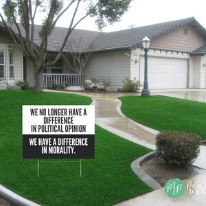 anti trump signs for protests in front yard that reads We no longer have a difference in political opinion, we have a difference in morality