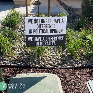 Protect democracy human rights yard sign in black and white with wording we no longer have a difference in political opinion we have a difference in morality