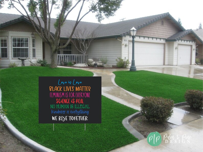 May include: A black yard sign with colourful text that reads "Love is Love, Black Lives Matter, Feminism is for Everyone, Science is Real, No Human is Illegal, Kindness is Everything, We Rise Together".