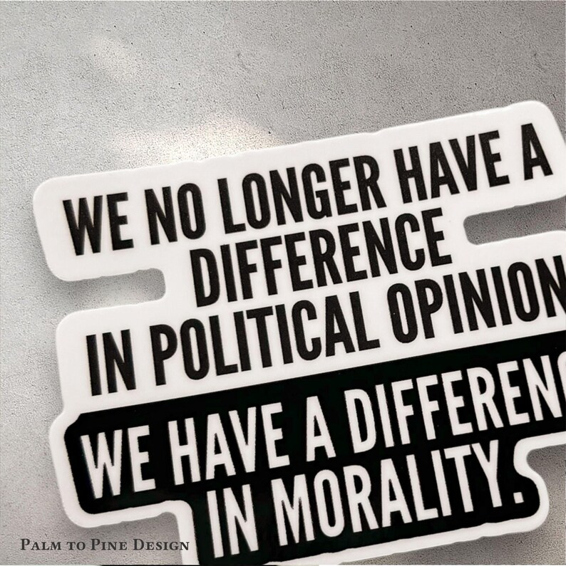 black and white activism sticker reading "We no longer have a difference in political opinion, we have a difference in morality" in black and white with modern font print