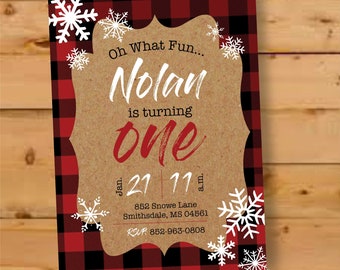 May include: A birthday invitation with a red and black buffalo plaid border and snowflake accents. The invitation features the text "Oh What Fun... Nolan is turning one" in white and red. The date and time are also included.
