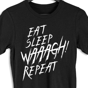 May include: Black t-shirt with white text that reads "Eat Sleep WAAAGH! Repeat".