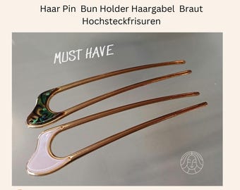 Een aloude haarspeld voor opgestoken kapsels, haarvork, knothouder, knotspeld met parelmoer in wit.