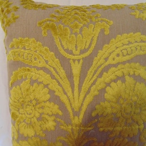 May include: A decorative throw pillow with a beige background and a yellow floral pattern.
