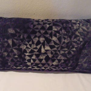 May include: A black and grey patterned throw pillow with a geometric design.