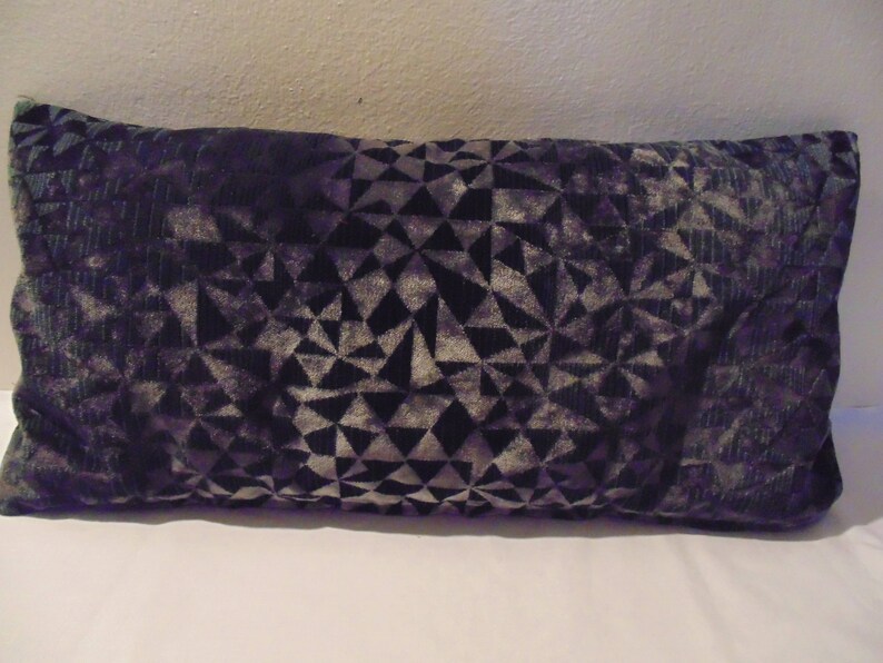 May include: A black and grey patterned throw pillow with a geometric design.