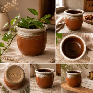 May include: A collection of handmade ceramic planters in various views. The planters are a warm brown color with a white and red-orange rim. One planter is filled with a green leafy plant. The planters have a rustic, earthy aesthetic.