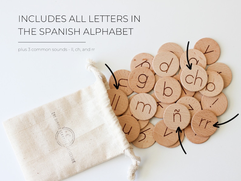 May include: A set of wooden letter tiles in a white drawstring bag. The tiles feature the letters of the Spanish alphabet, including the letters 'ch', 'll', and 'rr'.
